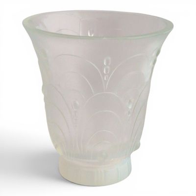 a glass vase that is sitting on a white surface