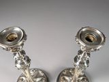 pair of silver candlesticks on a white background