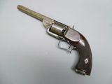 a close up of a gun on a table with a white background