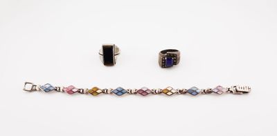 quelques bracelets et une bague posés sur une surface blanche