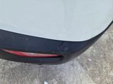 a close up of a car ' s tail light and bumper