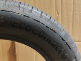 tire tread of a motorcycle on the floor next to a cardboard box