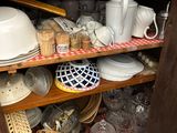 a cabinet full of dishes and cups and plates