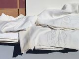 a pile of folded towels sitting on a window sill
