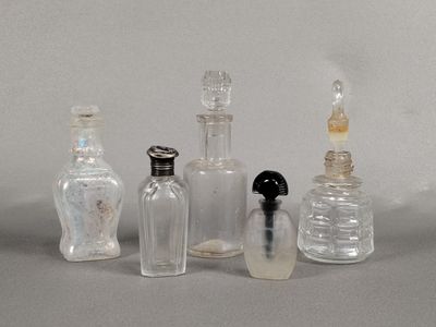 five glass bottles that are lined up on a table