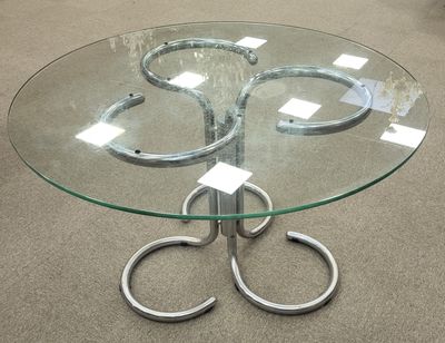 a glass table with a pair of scissors on top of it