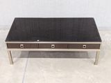 a coffee table with two drawers and a glass top