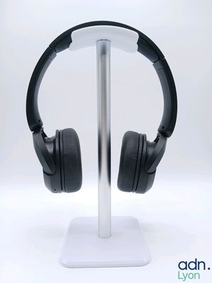 a pair of headphones on a stand on a white background