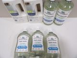several bottles of hand sanitizer sitting on top of a counter