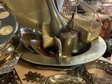 a lot of silverware on a table in a store