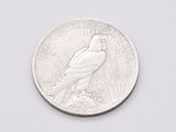 a close up of a silver coin with a bird on it