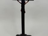 black cross on a wooden base with a cross on the top of it