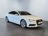 a white audi sedan parked in a white room