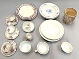 many different types of dishes and cups on the table