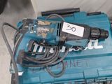 a blue drill sitting on top of a blue box