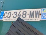 a close up of a street sign on the side of a building