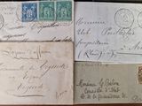 several old envelopes are sitting on top of a wooden table