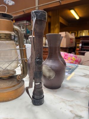 a lamp that is sitting on a table next to a vase