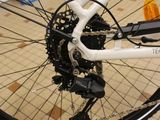 a white bicycle with a black and white front wheel and a black and white rear wheel and a white bicycle with a black and white front wheel and white