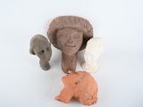 a clay sculpture of a woman and two elephants and a bear
