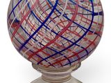 a glass ball with a red and blue design on it