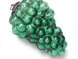 green glass grapes ornament on a white background