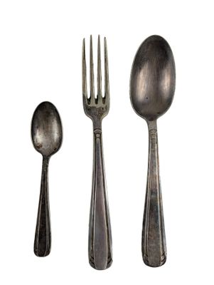 three spoons and a fork sitting next to each other