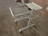 a small table with a tray on it in the dirt