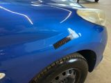 a blue car that has a sticker on the side of it