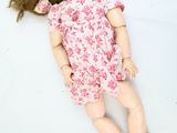 a doll that is laying down on the ground