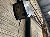 a television hanging on the side of a building