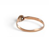 a close up of a gold ring with a flower on it