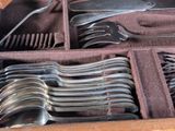 a lot of spoons and forks in a case