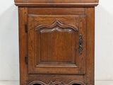 an old wooden cabinet with a door on the top of it