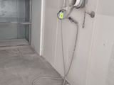 an image of a bathroom with a shower head and a hose