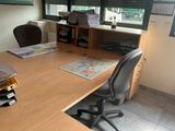 a desk with a chair and a computer on it