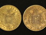 two gold coins, one of which has a crown and the other of which is a coat of arms
