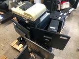 a pile of computer monitors and other electronics on the floor