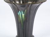 a black vase with a green and blue design on it
