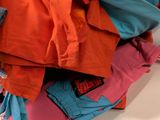 a person that is holding a pile of clothes