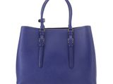 a blue leather tote bag with two handles on a white background