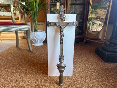 a cross that is sitting on the floor in front of a door