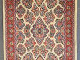an antique persian rug with a floral design on a blue ground