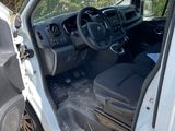 the interior of a car with the door open and the driver ' s seat down