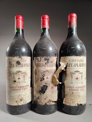 trois bouteilles de vin rouge posées côte à côte sur une table