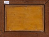 a close up of a picture of a wooden frame with a label on it