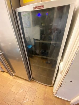 a refrigerator with a glass door in a kitchen