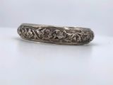 a silver ring with a floral design on it