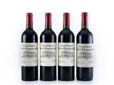 three bottles of wine are lined up on a white surface