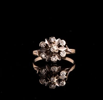 a close up of a diamond ring on a black surface